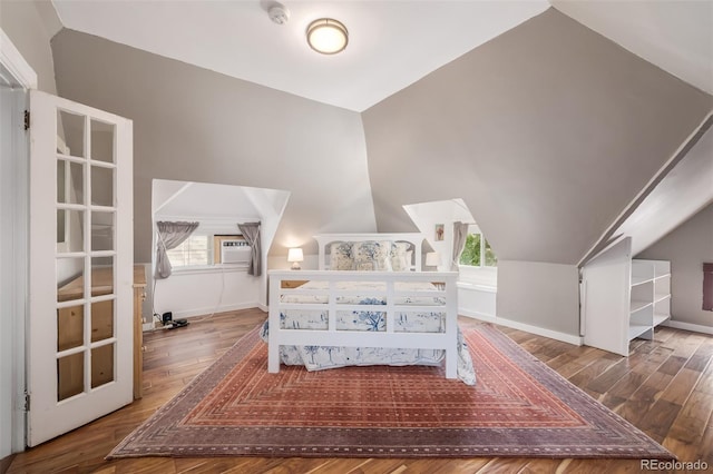 bedroom with vaulted ceiling and hardwood / wood-style floors