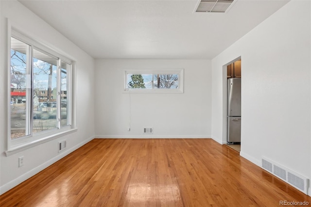 7180 Zuni St, Denver, CO 80221 - empty room with light wood-style flooring and visible vents