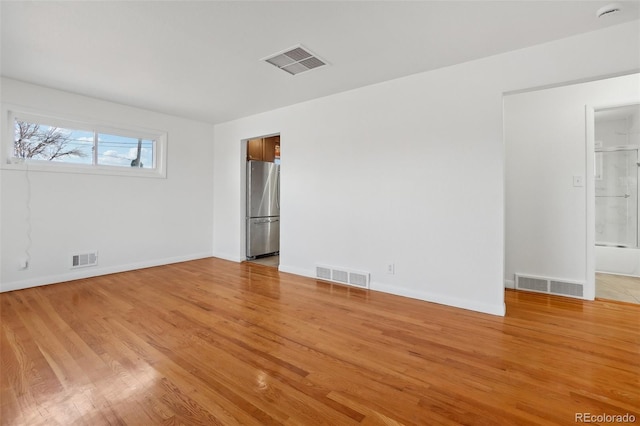 7180 Zuni St, Denver, CO 80221 - spare room featuring visible vents and light wood-type flooring
