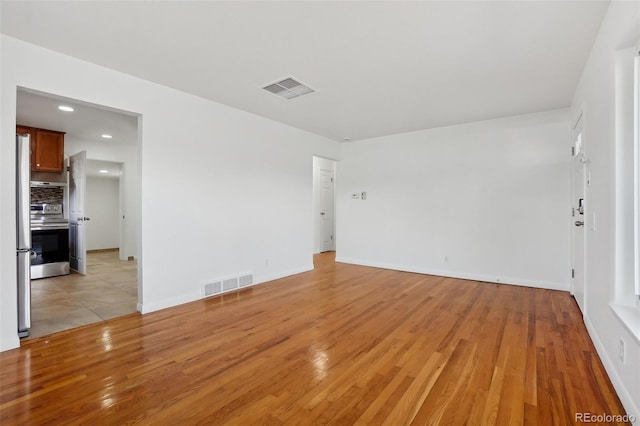 7180 Zuni St, Denver, CO 80221 - empty room with recessed lighting, visible vents, baseboards, and light wood-style flooring
