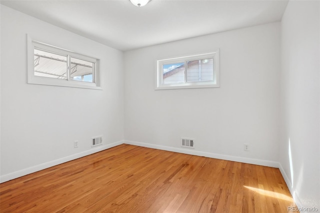 7180 Zuni St, Denver, CO 80221 - unfurnished room featuring light wood-type flooring, visible vents, and a healthy amount of sunlight