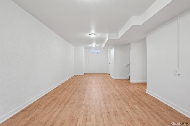 7180 Zuni St, Denver, CO 80221 - finished basement with stairway, light wood-type flooring, and baseboards