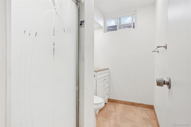 7180 Zuni St, Denver, CO 80221 - bathroom with vanity, toilet, and baseboards