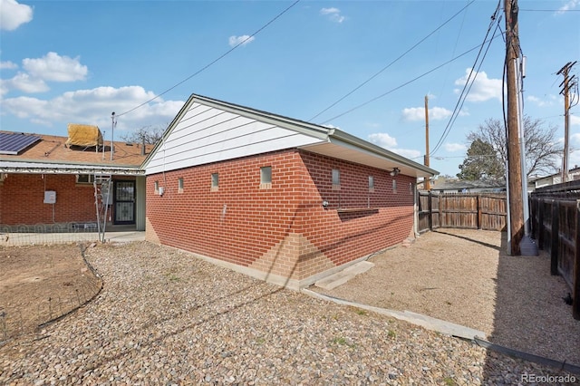 7180 Zuni St, Denver, CO 80221 - view of side of property with brick siding and a fenced backyard