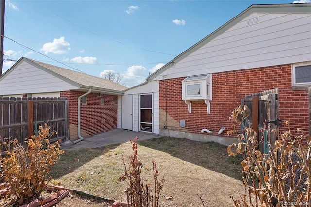7180 Zuni St, Denver, CO 80221 - rear view of property with brick siding and fence