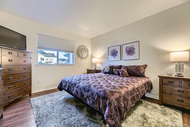 5757 S Algonquian Way Unit E, Aurora, CO 80016 - bedroom with dark wood-style flooring and baseboards