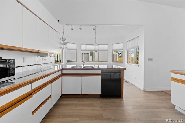 kitchen with light wood-style floors, white cabinets, dishwasher, and a sink