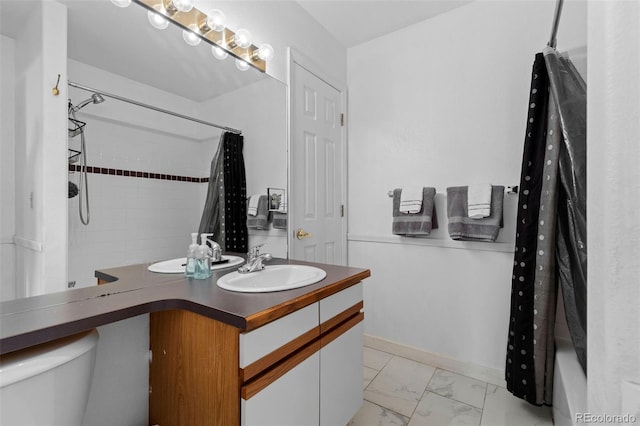 bathroom featuring toilet, marble finish floor, shower / tub combo with curtain, and vanity