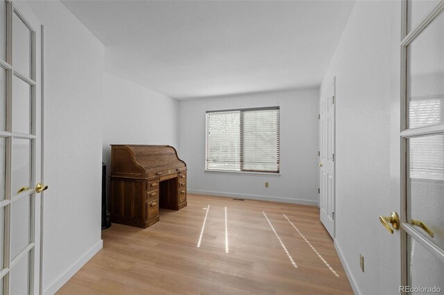 unfurnished bedroom with light wood-style flooring and baseboards