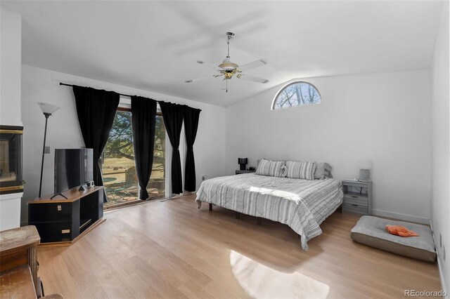 bedroom with vaulted ceiling, wood finished floors, and a ceiling fan