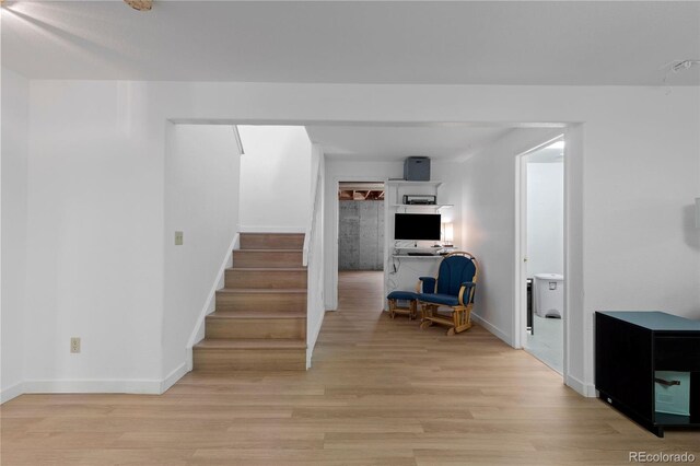 stairway featuring baseboards and wood finished floors