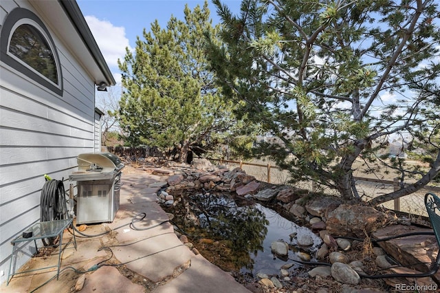 view of patio / terrace featuring grilling area and fence