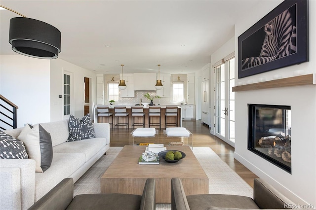 living area featuring baseboards and wood finished floors