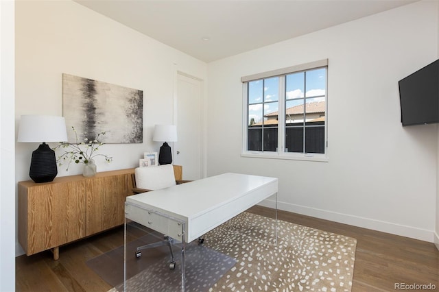 home office featuring baseboards and wood finished floors