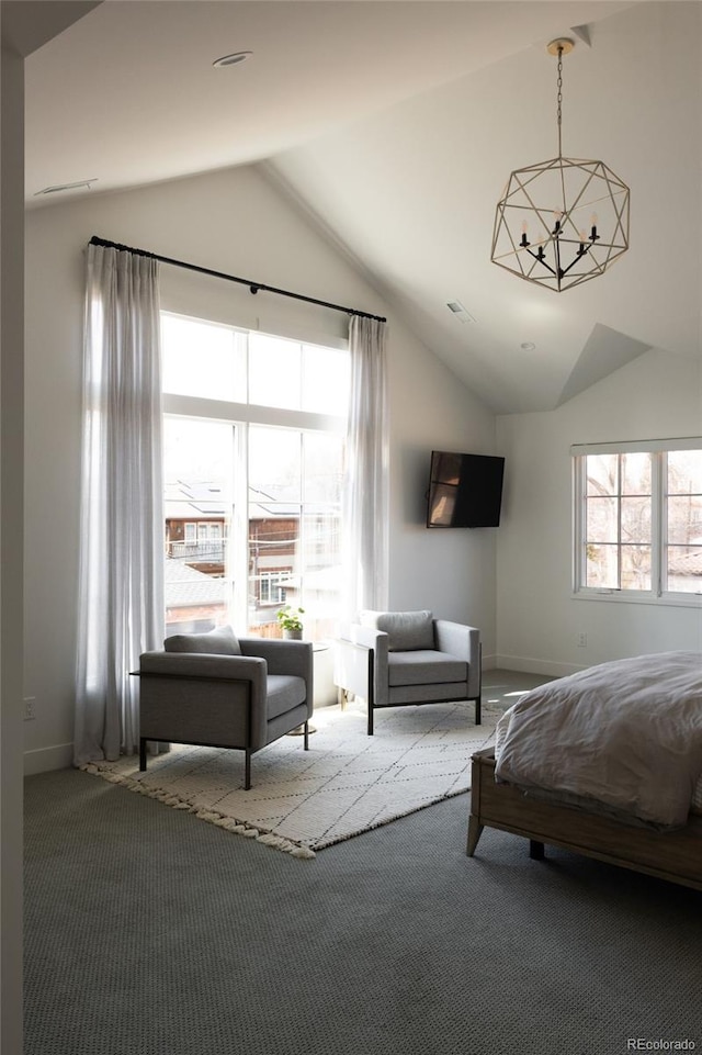 carpeted bedroom featuring baseboards, lofted ceiling, and a chandelier