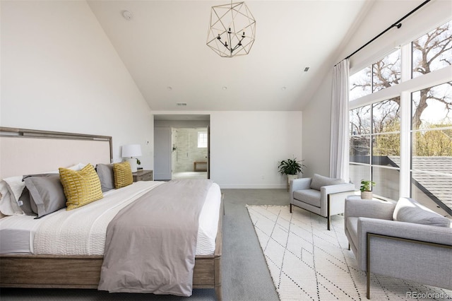 bedroom with carpet floors, high vaulted ceiling, ensuite bath, and baseboards