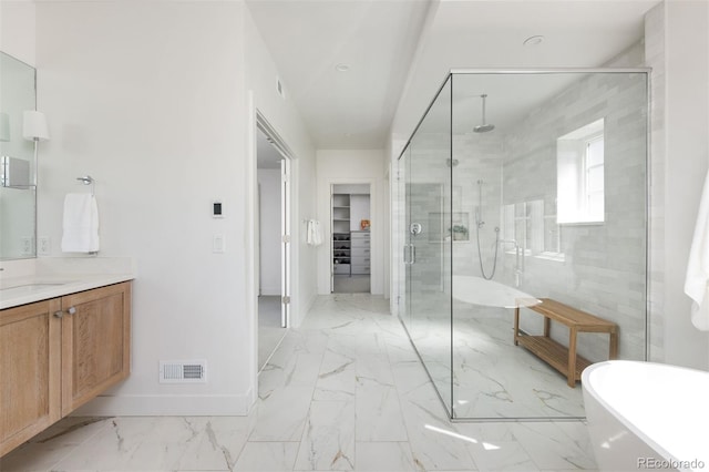 bathroom featuring a stall shower, vanity, marble finish floor, visible vents, and a freestanding bath