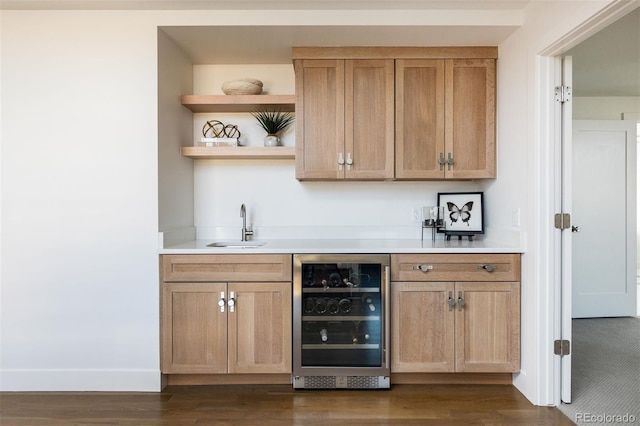 bar featuring dark wood-style floors, beverage cooler, wet bar, and a sink