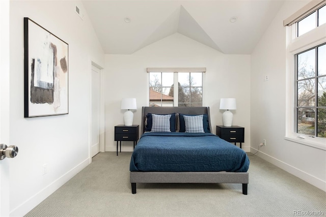 carpeted bedroom featuring multiple windows, vaulted ceiling, visible vents, and baseboards