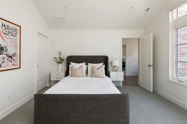 bedroom featuring light colored carpet, baseboards, vaulted ceiling, and visible vents
