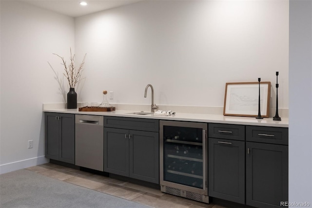 bar with recessed lighting, wet bar, a sink, beverage cooler, and dishwasher