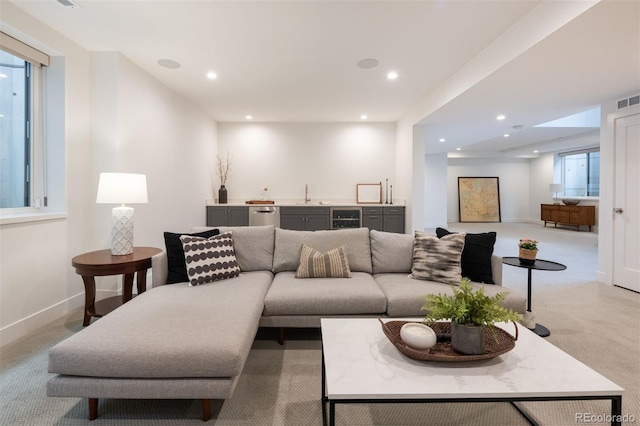 living room featuring visible vents, wine cooler, recessed lighting, indoor wet bar, and light colored carpet