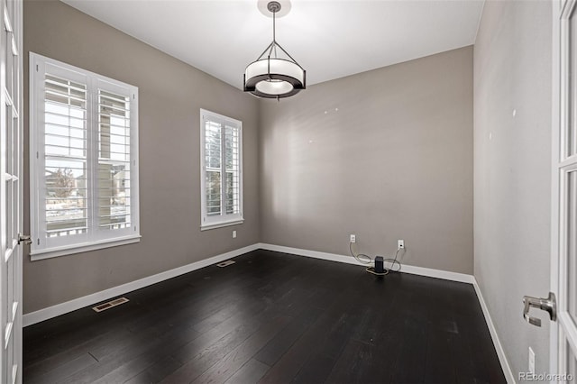 spare room featuring wood-type flooring