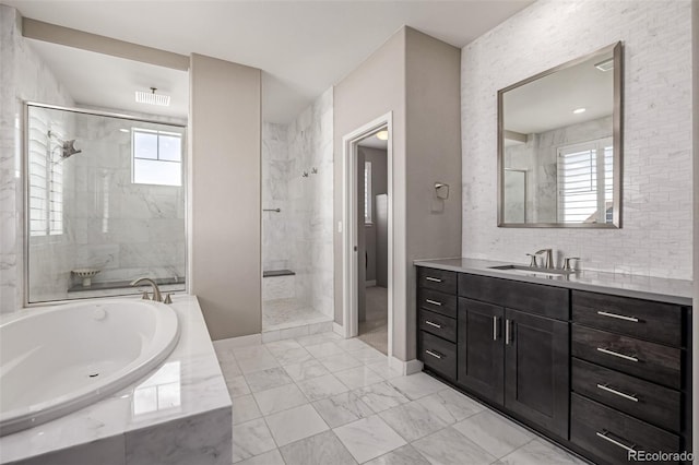 bathroom with vanity and independent shower and bath