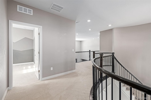 hallway with light colored carpet