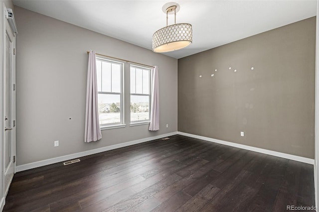 unfurnished room with dark hardwood / wood-style flooring