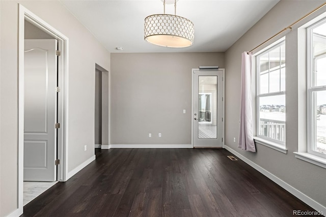 spare room featuring dark hardwood / wood-style flooring