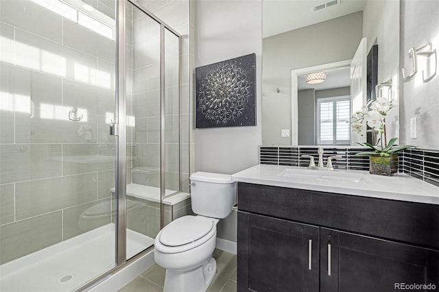 bathroom with vanity, an enclosed shower, decorative backsplash, tile patterned floors, and toilet