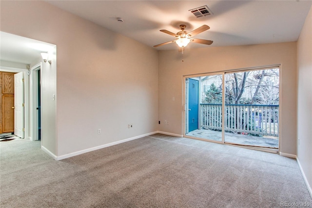 carpeted empty room with visible vents, baseboards, lofted ceiling, and ceiling fan