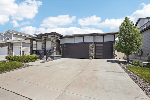 5680 Saddle Skirt St, Parker, CO 80134 - view of front of home featuring stone siding, concrete driveway, and an attached garage