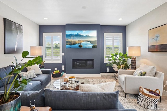5680 Saddle Skirt St, Parker, CO 80134 - living area featuring a glass covered fireplace, wood finished floors, and recessed lighting