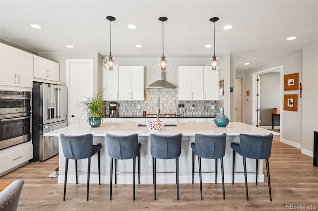5680 Saddle Skirt St, Parker, CO 80134 - kitchen featuring stainless steel appliances, tasteful backsplash, a breakfast bar area, white cabinets, and recessed lighting