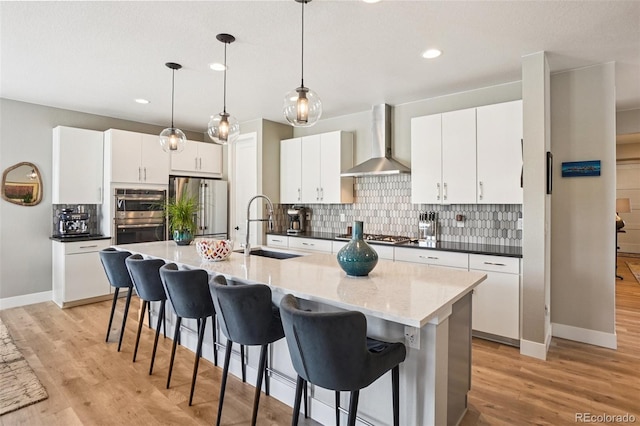 5680 Saddle Skirt St, Parker, CO 80134 - kitchen featuring wall chimney range hood, stainless steel appliances, decorative backsplash, a breakfast bar, and recessed lighting