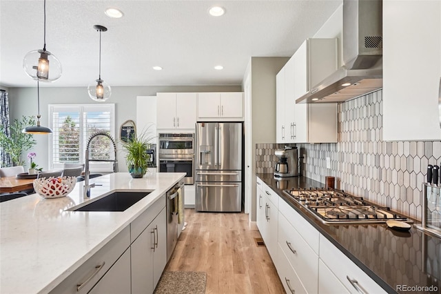 5680 Saddle Skirt St, Parker, CO 80134 - kitchen with stainless steel appliances, wall chimney range hood, tasteful backsplash, decorative light fixtures, and recessed lighting