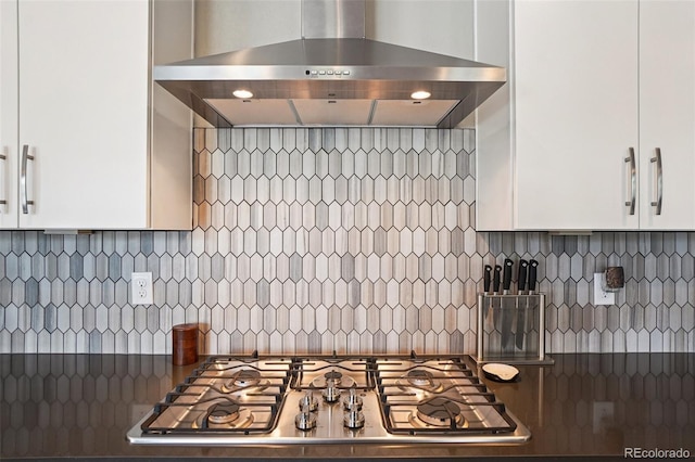 5680 Saddle Skirt St, Parker, CO 80134 - kitchen with wall chimney exhaust hood, stainless steel gas cooktop, white cabinets, and backsplash