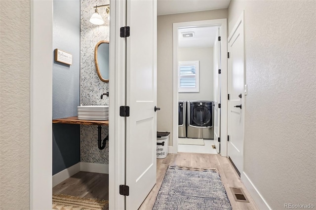 5680 Saddle Skirt St, Parker, CO 80134 - hall with separate washer and dryer, wood finished floors, and a textured wall