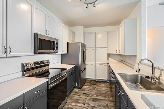 14251 E 1st Dr Unit 305, Aurora, CO 80011 - kitchen featuring appliances with stainless steel finishes, dark wood-style flooring, white cabinets, and light countertops