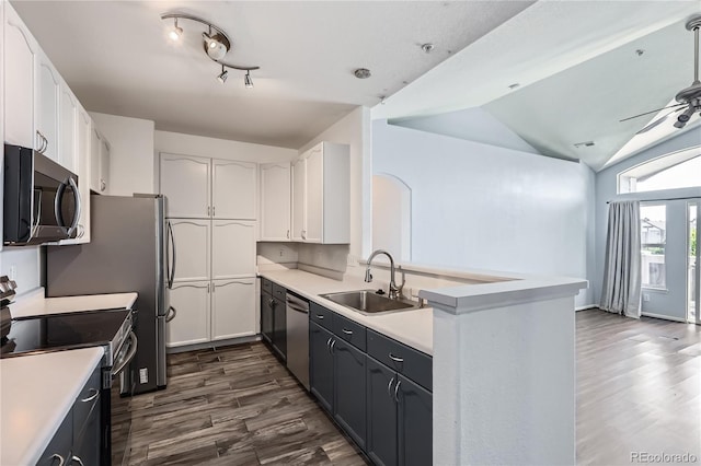 14251 E 1st Dr Unit 305, Aurora, CO 80011 - kitchen featuring stainless steel appliances, dark wood-style floors, white cabinetry, a peninsula, and lofted ceiling
