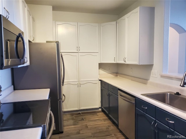 14251 E 1st Dr Unit 305, Aurora, CO 80011 - kitchen featuring appliances with stainless steel finishes, dark wood-type flooring, white cabinets, and light countertops