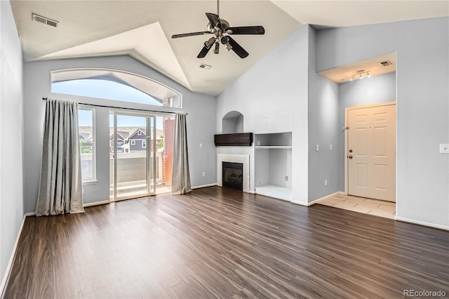 14251 E 1st Dr Unit 305, Aurora, CO 80011 - unfurnished living room with a ceiling fan, a tile fireplace, wood finished floors, and high vaulted ceiling