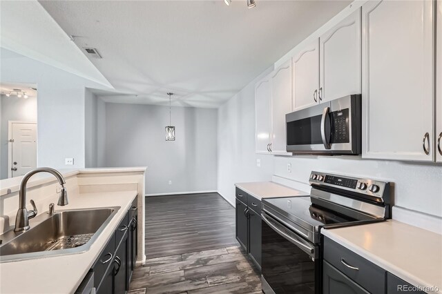 14251 E 1st Dr Unit 305, Aurora, CO 80011 - kitchen with stainless steel appliances, dark wood-style flooring, light countertops, and vaulted ceiling