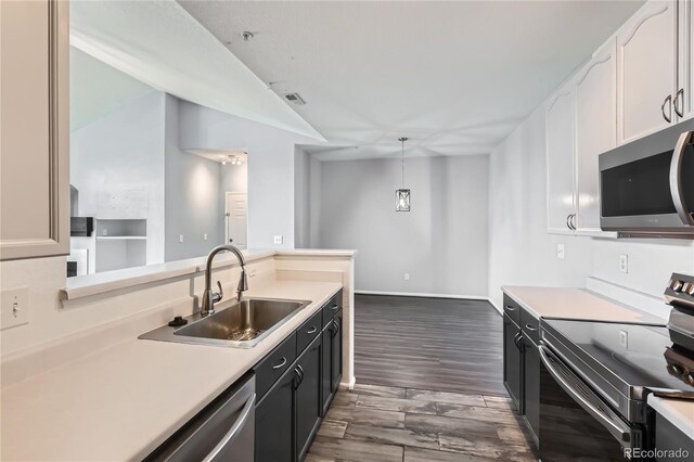 14251 E 1st Dr Unit 305, Aurora, CO 80011 - kitchen with appliances with stainless steel finishes, light countertops, dark wood-style floors, and white cabinetry