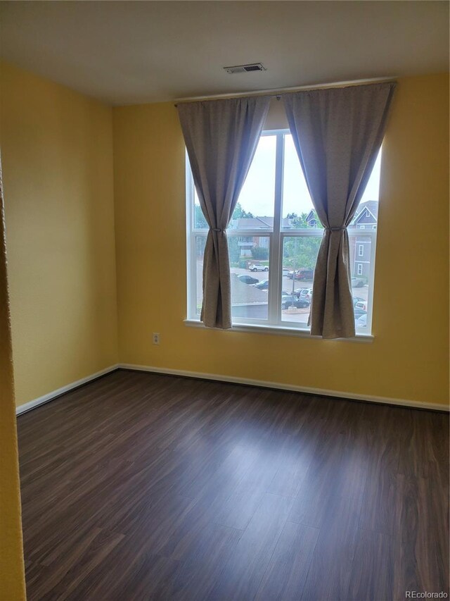 14251 E 1st Dr Unit 305, Aurora, CO 80011 - spare room with dark wood-style flooring and baseboards