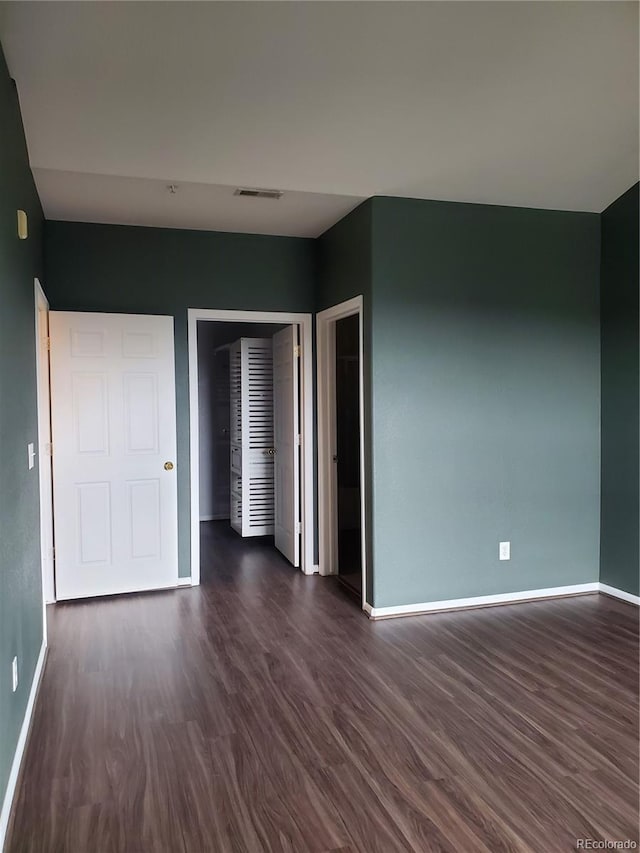 14251 E 1st Dr Unit 305, Aurora, CO 80011 - unfurnished bedroom featuring dark wood finished floors and baseboards
