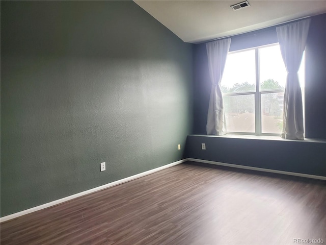 14251 E 1st Dr Unit 305, Aurora, CO 80011 - spare room featuring wood finished floors, lofted ceiling, and a textured wall