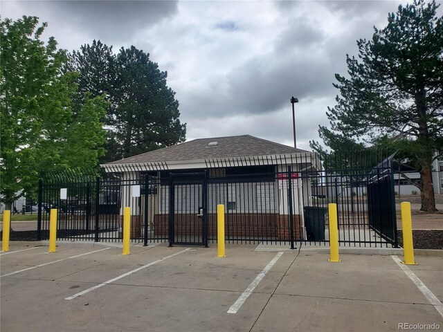 14251 E 1st Dr Unit 305, Aurora, CO 80011 - view of property's community featuring uncovered parking and a gate